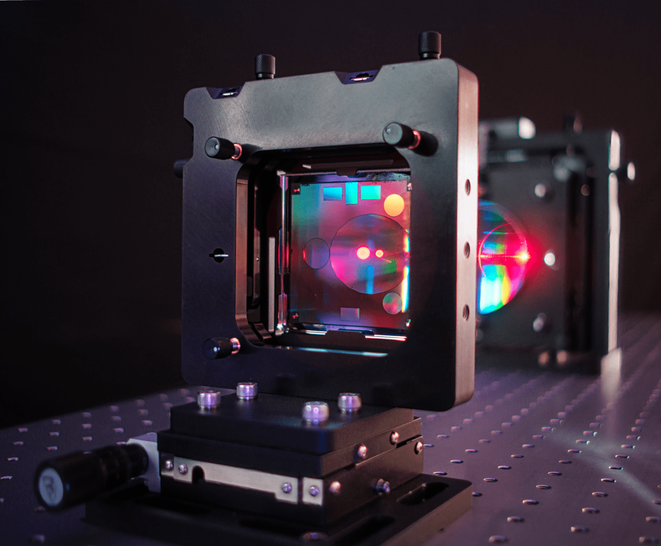 A computer-generated hologram (CGH) with alignment patterns shines rainbows of light reflected from a convex optic metrology system