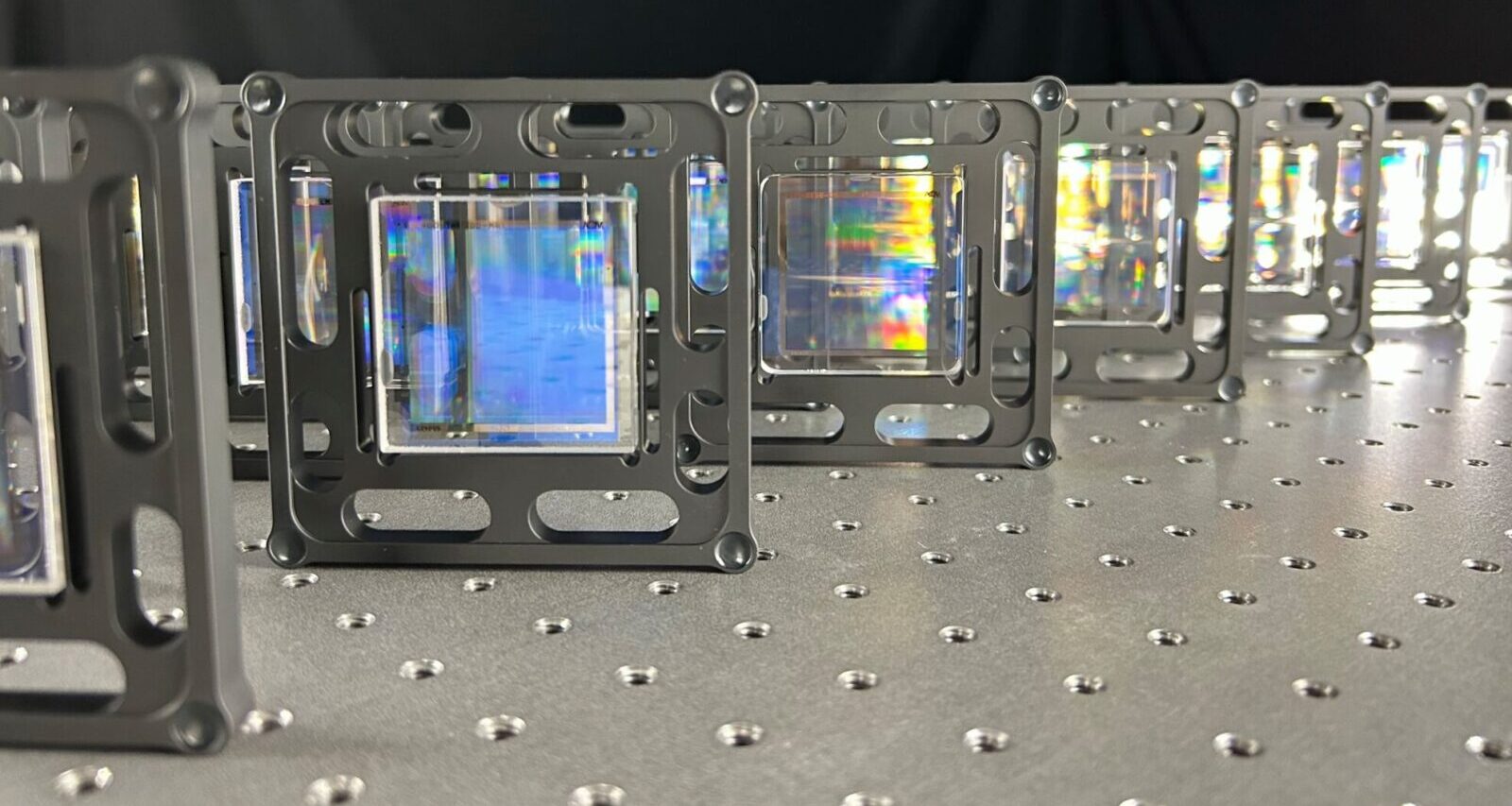 AOM computer-generated holograms (CGHs) used for measuring cylinder optics standing on a table